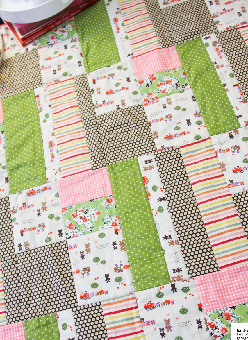 Pink, green, red and brown 'little trains' gender neutral cot quilt on For the Love of George